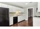 Bright kitchen featuring white cabinets, black appliances, and hardwood floors at 3454 Ashwood Ln, Atlanta, GA 30341
