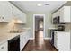 Kitchen boasting white cabinets, stainless steel appliances, and wood flooring at 3454 Ashwood Ln, Atlanta, GA 30341
