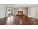 Open living room with hardwood floors, cozy fireplace and sliding glass door leading to the backyard at 3454 Ashwood Ln, Atlanta, GA 30341