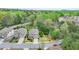 Aerial view showing property lines of a brick home with manicured lawn surrounded by lush greenery and neighborhood at 6845 Rocking Horse Ln, Cumming, GA 30040
