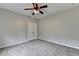 Bedroom featuring neutral carpet, ceiling fan and closet at 6845 Rocking Horse Ln, Cumming, GA 30040