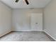 Empty bedroom featuring neutral carpet and a double door closet at 6845 Rocking Horse Ln, Cumming, GA 30040