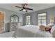 Bedroom with dresser, two windows providing natural light, ceiling fan and carpet at 6845 Rocking Horse Ln, Cumming, GA 30040