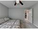 Comfortable bedroom featuring a queen-sized bed, ceiling fan, and a laundry room view at 6845 Rocking Horse Ln, Cumming, GA 30040