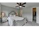 Bedroom with beautiful bed, ceiling fan, carpet and adjacent walk-in closet at 6845 Rocking Horse Ln, Cumming, GA 30040