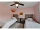 Cozy bedroom featuring twin beds, desk, ceiling fan, and soft carpeting offering a comfortable and stylish retreat at 6845 Rocking Horse Ln, Cumming, GA 30040