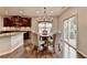 Bright dining area with chandelier located adjacent to a beautifully appointed kitchen at 6845 Rocking Horse Ln, Cumming, GA 30040