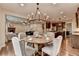 Open concept living room and kitchen area next to a dining space at 6845 Rocking Horse Ln, Cumming, GA 30040