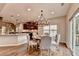 Inviting dining area features wood floors, a chandelier, and sliding glass door to deck at 6845 Rocking Horse Ln, Cumming, GA 30040