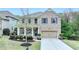 Charming brick two-story home with manicured landscaping and a two-car garage at 6845 Rocking Horse Ln, Cumming, GA 30040