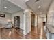 Open hallway with hardwood floors and decorative wall paneling leading to rooms at 6845 Rocking Horse Ln, Cumming, GA 30040