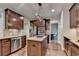 Gourmet kitchen features stainless steel appliances, rich wood cabinetry and granite countertops at 6845 Rocking Horse Ln, Cumming, GA 30040