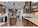 This kitchen boasts a center island, stainless steel appliances, and granite counters at 6845 Rocking Horse Ln, Cumming, GA 30040