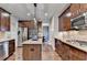 Gourmet kitchen features stainless steel appliances, rich wood cabinetry and granite countertops at 6845 Rocking Horse Ln, Cumming, GA 30040