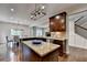 Gourmet kitchen adjacent to living room has granite countertops at 6845 Rocking Horse Ln, Cumming, GA 30040