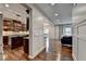 Open concept kitchen with wood floors adjacent to living area at 6845 Rocking Horse Ln, Cumming, GA 30040
