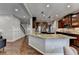 Spacious kitchen with a large island, stainless steel appliances, and hardwood flooring at 6845 Rocking Horse Ln, Cumming, GA 30040
