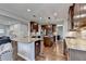 Open-concept kitchen features a large island, stainless appliances, and hardwood floors at 6845 Rocking Horse Ln, Cumming, GA 30040