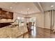 Kitchen featuring granite countertops, stainless steel appliances, dark wood cabinets and hardwood floors at 6845 Rocking Horse Ln, Cumming, GA 30040
