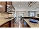 Spacious kitchen featuring stainless gas range and breakfast bar at 6845 Rocking Horse Ln, Cumming, GA 30040