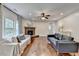 Bright living room featuring stone fireplace and hardwood floors at 6845 Rocking Horse Ln, Cumming, GA 30040