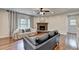 Open living room with fireplace, hardwood floors and large windows at 6845 Rocking Horse Ln, Cumming, GA 30040