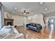 Spacious living room with stone fireplace, ceiling fan and hardwood floors at 6845 Rocking Horse Ln, Cumming, GA 30040