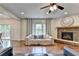 Bright living room with hardwood floors, fireplace and access to outdoor deck at 6845 Rocking Horse Ln, Cumming, GA 30040