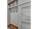 Mudroom with bench, hooks, storage, and decorative wall trim at 6845 Rocking Horse Ln, Cumming, GA 30040