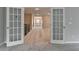 Open upstairs landing with open french doors and neutral carpeting at 6845 Rocking Horse Ln, Cumming, GA 30040
