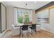 Dining room featuring a modern light fixture and views of the outdoors at 125 Werner Brook Sw Way, Atlanta, GA 30354