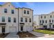 Attractive townhome boasts an attached garage, a covered entry, and a well-manicured lawn at 125 Werner Brook Sw Way, Atlanta, GA 30354