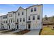 Attractive three-story townhome boasts an attached garage, a covered entry, and a beautifully landscaped yard at 125 Werner Brook Sw Way, Atlanta, GA 30354