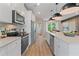 Bright kitchen featuring white cabinets, stainless steel appliances, and a spacious island with pendant lighting at 125 Werner Brook Sw Way, Atlanta, GA 30354