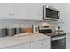 Close-up of a modern kitchen with stainless steel appliances, quartz countertops, and stylish decor at 125 Werner Brook Sw Way, Atlanta, GA 30354