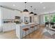 Modern white kitchen features stainless steel appliances and a large center island with bar stool seating at 125 Werner Brook Sw Way, Atlanta, GA 30354
