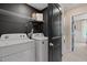 Modern laundry room with a white washer and dryer and wire shelving at 125 Werner Brook Sw Way, Atlanta, GA 30354