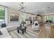 Open floor plan with a modern living room flowing into a kitchen with island and dining area at 125 Werner Brook Sw Way, Atlanta, GA 30354