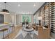 Bright, modern living room with a large wine rack and adjacent dining area at 125 Werner Brook Sw Way, Atlanta, GA 30354