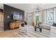 Elegant living room with dark accent wall, stylish furniture, and ample natural light from large windows at 125 Werner Brook Sw Way, Atlanta, GA 30354