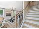 View of a modern staircase leading to the upper level, with a glimpse of the open-concept living area at 125 Werner Brook Sw Way, Atlanta, GA 30354