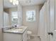 Bathroom featuring granite countertops, tile flooring, and a shower with glass doors at 1916 Cannon St, Decatur, GA 30032
