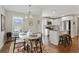 Cozy dining room next to a bright kitchen with white cabinets and a hardwood floor at 1916 Cannon St, Decatur, GA 30032