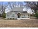 Charming grey two-story home featuring a welcoming front porch and mature trees at 1916 Cannon St, Decatur, GA 30032