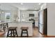 Bright kitchen featuring stainless steel appliances, a breakfast bar, granite countertops, and hardwood flooring at 1916 Cannon St, Decatur, GA 30032