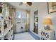 Bright sunroom with painted brick, white shelves, and colorful, floral curtains at 1916 Cannon St, Decatur, GA 30032