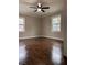 Cozy bedroom featuring hardwood flooring, two windows, neutral paint and white trim at 197 Upshaw Sw St, Atlanta, GA 30315