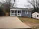 Charming single-story home featuring a covered front porch, concrete driveway, and gray siding at 197 Upshaw Sw St, Atlanta, GA 30315