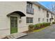 Charming exterior view of the building with a green door, brick facade, and well-maintained landscaping at 798 Saint Charles Ne Ave # 5, Atlanta, GA 30306