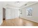 A bright bedroom features hardwood floors, a ceiling fan, and two large windows at 103 Timber Ridge Dr, Cartersville, GA 30121